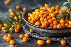 Fresh sea buckthorn berries displayed in rustic bowl with sprig photo