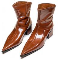 Pair of shiny brown ankle boots with pointed toe and block heel resting on white background photo