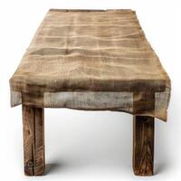 Rustic wooden table covered with burlap cloth on white background photo