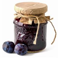 Glass jar of plum jam wrapped in brown paper and twine with fresh plums photo