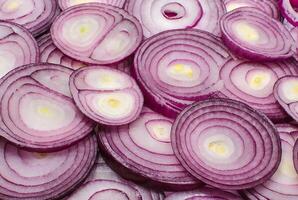 Sliced red onion rings close up as a background photo