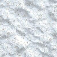 Top view photo of soft snow with small patches of glitter, seamless texture