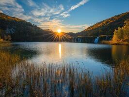 Majestic Waterfall at Sunset over a Serene Lake photo