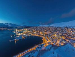 Arctic City at Night, Sparkling Lights on Snowy Hills photo