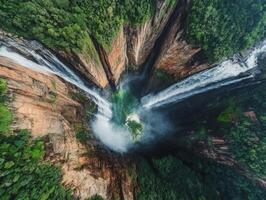 Aerial View of a Majestic Waterfall Cascading Through Lush Rainforest photo