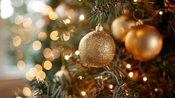 Close-up of a beautifully decorated Christmas tree with golden ornaments and soft glowing lights photo
