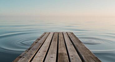 Serene Waterfront Scene with Wooden Deck and Calm Waters in Background. photo