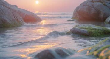 tranquilo costero escena con rocas y fluido agua a puesta de sol con suave pastel colores. foto