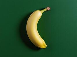 Single ripe yellow banana on green background photo