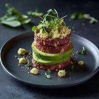 Delicious beef tartare appetizer with avocado and microgreens photo