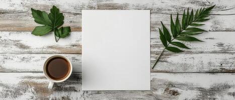 Blank paper with coffee and leaves on rustic wooden table photo