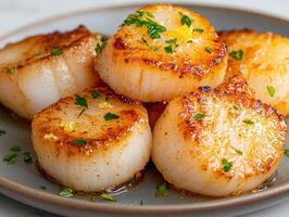 a pile of seared scallops with lemon and parsley. photo