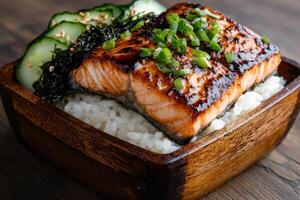 Delicious teriyaki glazed salmon with rice and cucumber photo