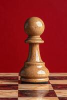 Close up of a wooden chess pawn on a chessboard photo