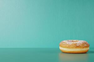 Glazed donut on teal background photo