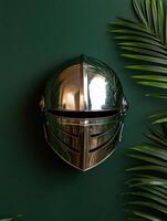 Medieval knight helmet with tropical leaves on dark green background photo