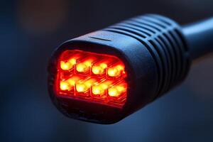 Close-Up of Glowing Red LED Lights in Black Connector for Electronics Background photo