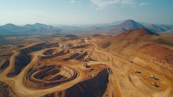 Excavators working in open pit mine extracting minerals in desert landscape photo