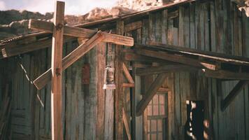 Old wooden structure with rustic lantern against rocky backdrop in daylight video
