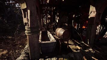 Rustic wooden structure with barrels and water trough in a natural setting video