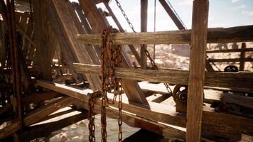 Rustic wooden structure with chains and intricate details in a canyon setting video