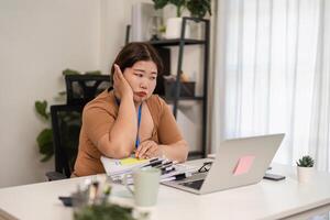 Overwhelmed female accountant struggling with multiple documents in a challenging office environment photo