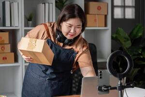 E-commerce entrepreneur managing shipments with a package at home office, showcasing online retail business photo