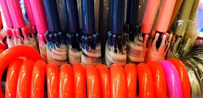Close up colorful of umbrella handle hanging for sale in miscellaneous shop. Color object and Beautiful concept. photo