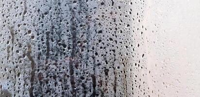 Art pattern of steam, vapor or water droplet on glass or mirror for background. Selective focus and Blurred. Humidity, Abstract wallpaper and wet after rain drop concept. photo