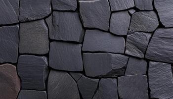 Dark stones are carefully placed together, forming a unique textured wall design photo