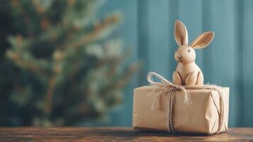 Easter DIY bunny and gift box on wooden table, retro toned with copy space for text photo