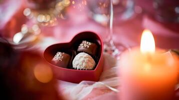 Warm Valentine's Day setting with heart-shaped chocolate box and candle glow photo