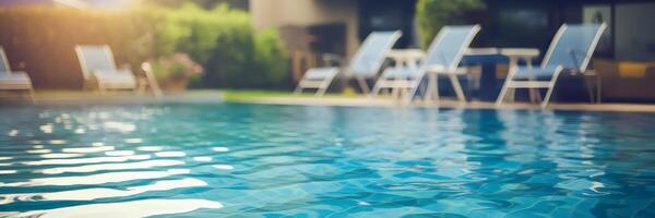 Blurred poolside scene with clear blue water and highlights photo