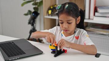 STEM education concept. Asian home school girls self-study online lessons and are excited to make STEM toys. mathematics engineering science technology computer code in robotics for photo
