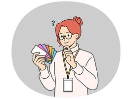 Woman designer holds palette of cards of different colors, choosing desired shade to use in design vector
