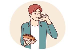 Man with burger licks fingers and enjoys reception of fast food bought in street restaurant vector