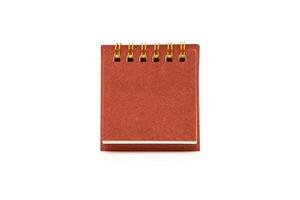 Blank red desk calendar isolated on white background. Blank paper desk spiral calendar. Copy Space and clipping path. photo