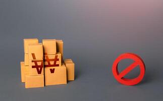 South korean won goods boxes and prohibition symbol NO. Trade wars. Oversupply. Confiscation of contraband. Shortage of goods. Sanctions and embargo. A ban on import of goods. photo