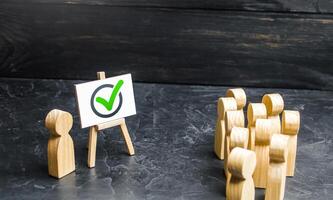 People and a vote check mark. Involving people in solving the problem. Campaigning for voting for a project or political candidate. Lobbying interests. Public poll. Report, briefing, presentation. photo