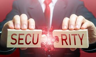 Man breaks the puzzle with word SECURITY. Security breach, hacker attack and data leak. Bypassing protection, hacking networks. Damage, disruption of work. Hybrid war. Vulnerability risks. Signaling photo