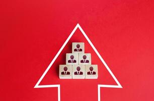 Business team group of people made of blocks in direction arrow. Strength in unity. Teamwork. Movement in a single group. Consolidation in a larger formation. Common interest, joint problem solving. photo