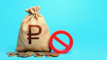 Russian ruble money bag and red prohibition sign NO. Monetary restrictions, freezing of bank accounts. Monitoring suspicious money flows. Confiscation of deposits. Termination projects. photo