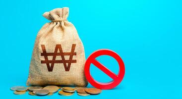 South korean won money bag and red prohibition sign NO. Monetary restrictions, freezing of bank accounts. Monitoring suspicious money flows. Termination projects. Confiscation of deposits. photo