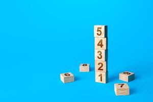 Numbers tower of wooden blocks. Simple steps. Organization and systematization. Business planning, action plan. Roadmap agreement Implementation of decisions, action stages. Instructions for work. photo