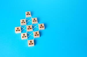 Connected people blocks on blue background. Concept of order, orderliness and uniform structure. Team building. Employee network. Human resource management, hiring and staffing. management strategies photo