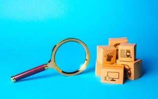 Boxes with goods and magnifying glass. Search for great deals and sales. Holiday sale. Monitoring and verification of goods, import certification. Quality control. Tracking products Localization photo