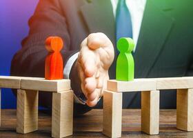 The man separates the disputes with his palm. Mediation and arbitration services. Ending an acute conflict and creating an alternative way to resolve dispute. Finding a compromise. Reducing tension photo