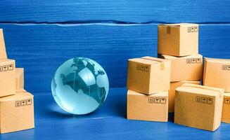 Planet Earth globe and cardboard boxes photo