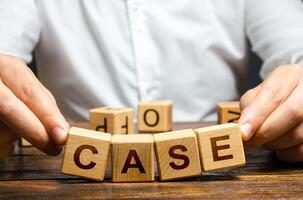 Man raises falling apart blocks with word Case. Concept of collapse of a trial, insufficient evidence, innocence. Closing court case. Defense lawyer attorney services. Failed indictment act photo