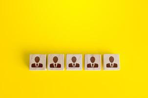 Blocks with employees in a row. Building a business team from many candidates. Personnel management, team formation for a new project. Cooperation and collaboration. Hiring and recruiting workers. photo